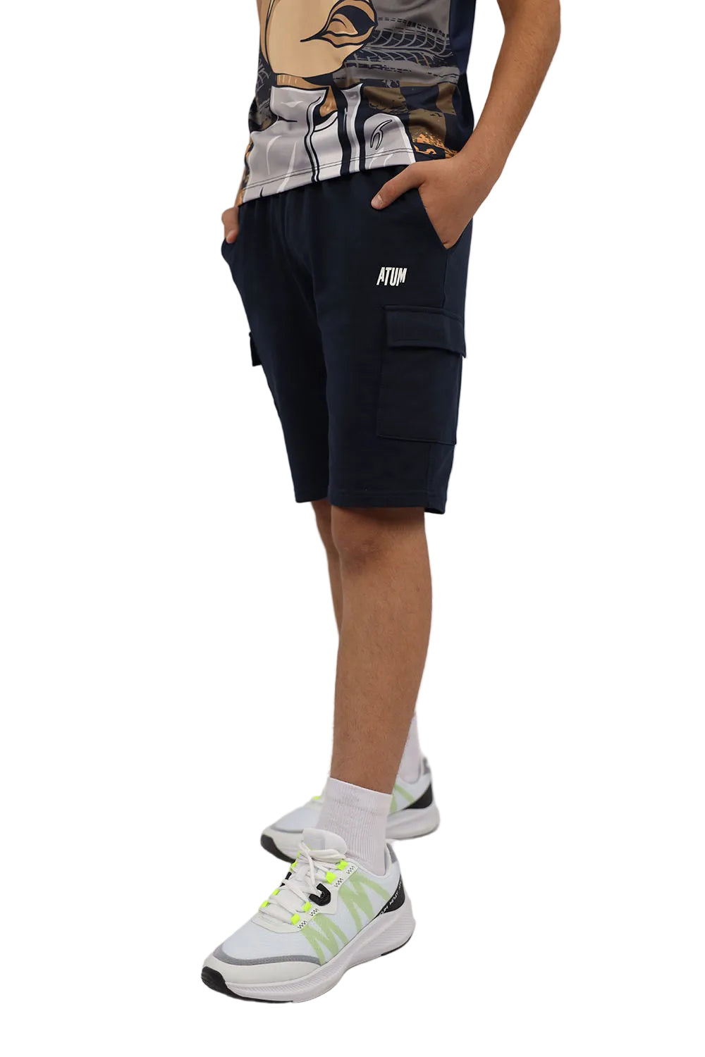 Person wearing navy cargo shorts with a brand logo on a plain background